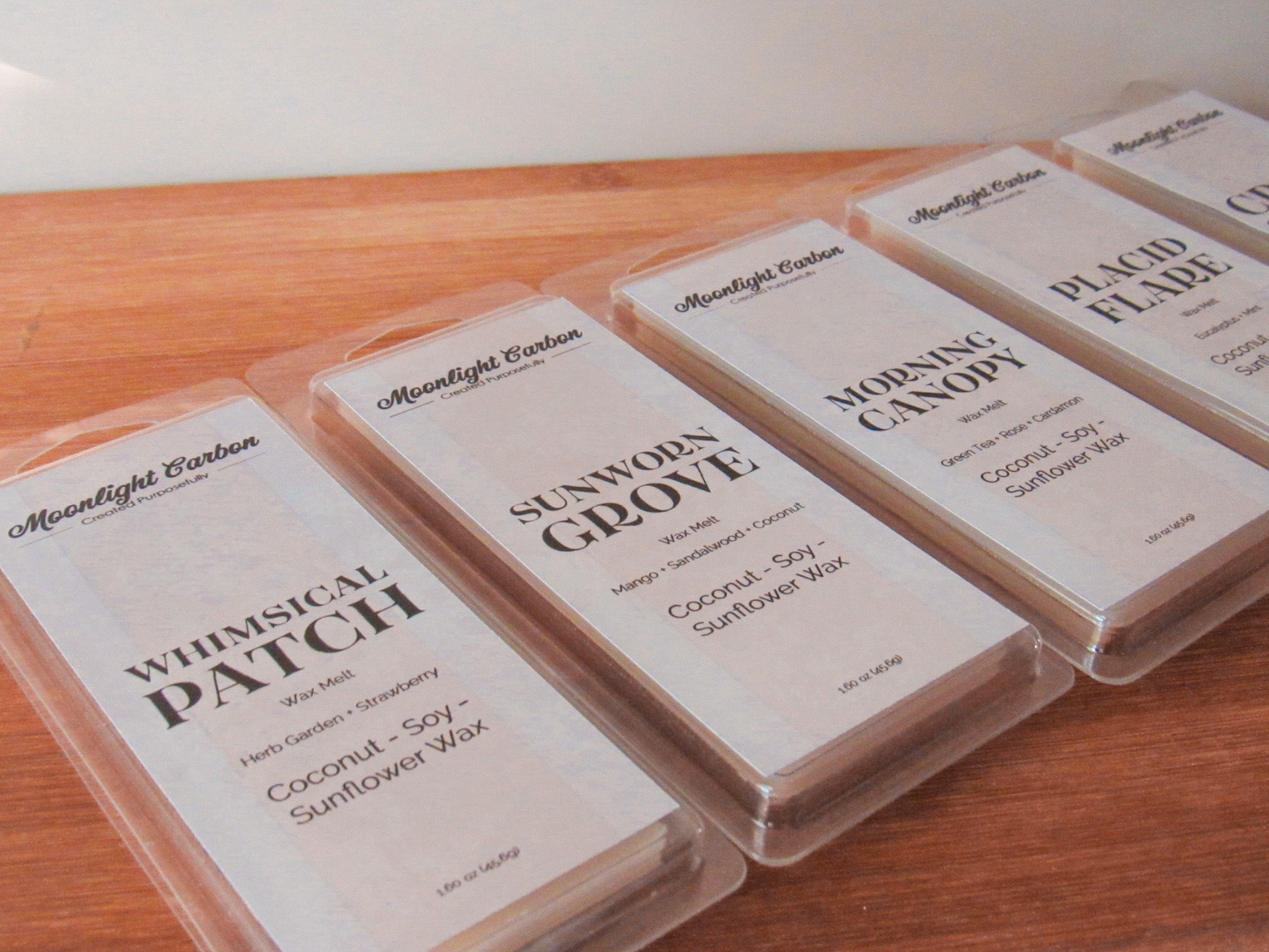 Wax melts with labels on a wooden surface and neutral background