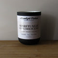 Coconut, soy, and palm wax candle labeled 'Spiritually Efflorescent' by Moonlight Carbon on a wooden surface with a neutral background. Fragrance notes include jasmine, marigold, and ylang ylang. 