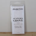 Wax melt package labeled 'Sunworn Grove' by Moonlight Carbon on a plain background. Fragrance notes include mango, sandalwood, and coconut.
