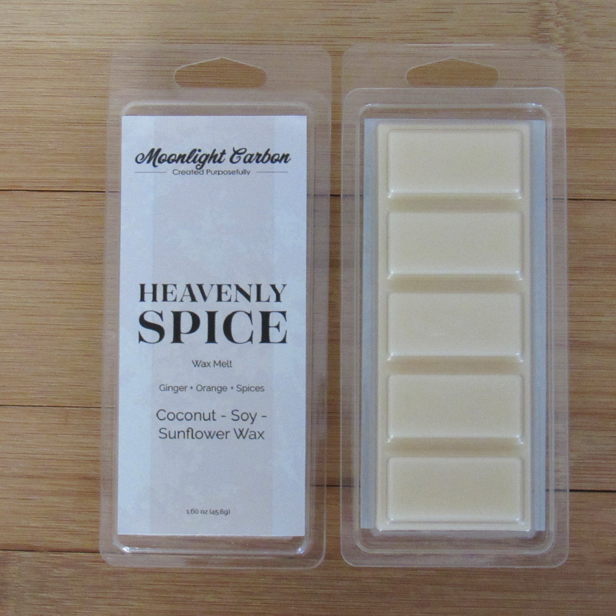 Wax melt packaging with 'Heavenly Spice' label on a wooden surface. Shows back of packaging with wax melts divided into 5 parts.