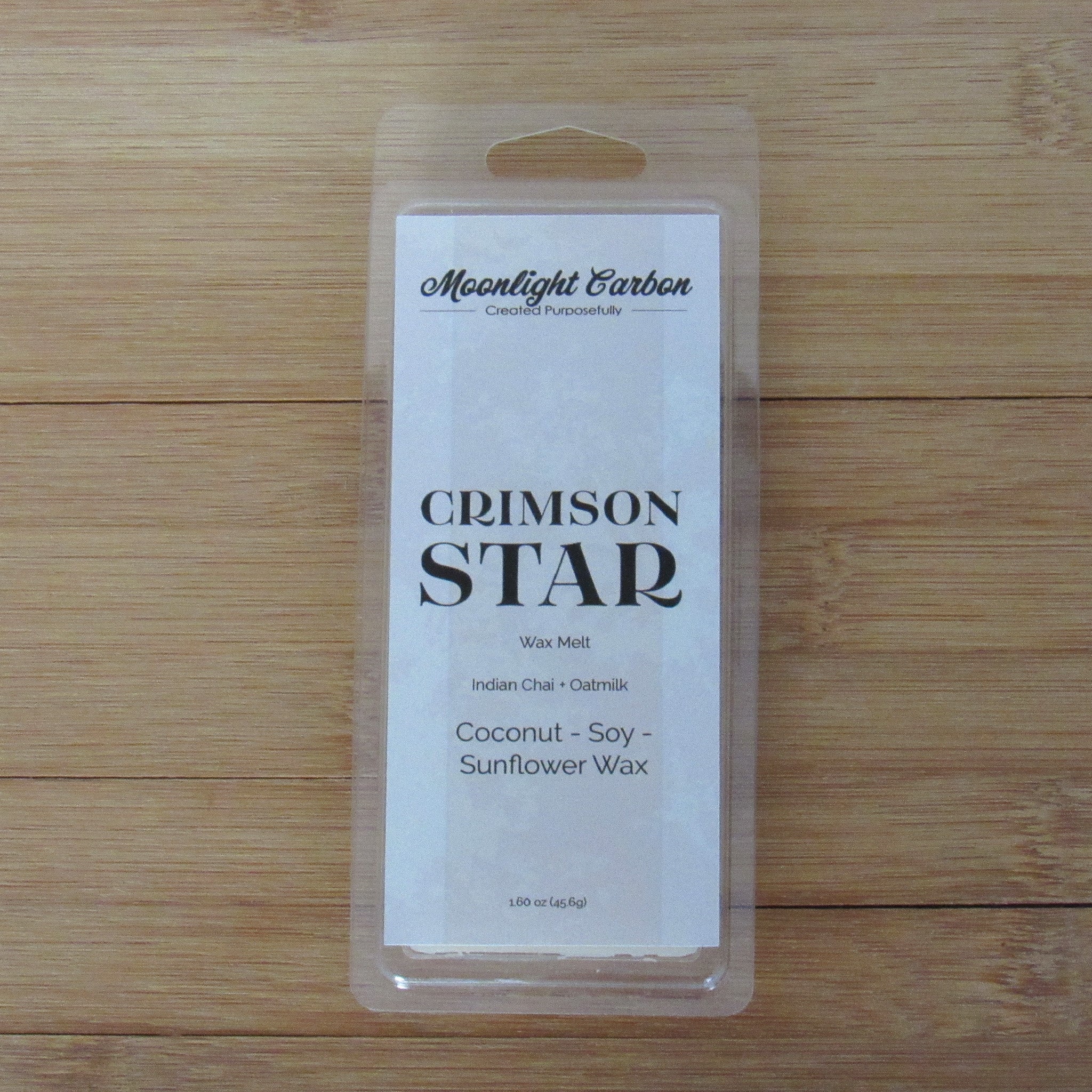 Wax melt packaging labeled 'Crimson Star' on a wooden surface