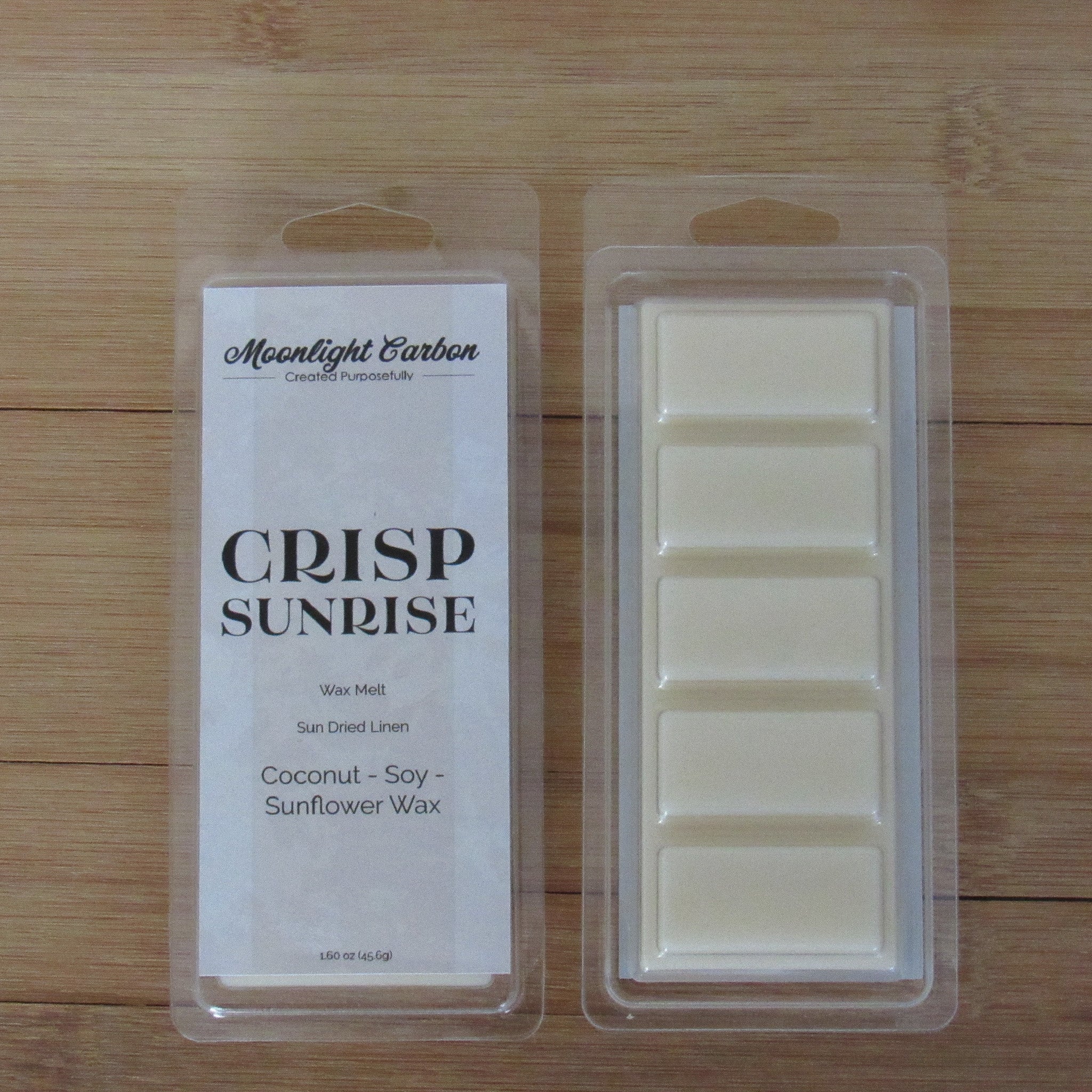 Wax melt packaging with label on a wooden surface. Shows back of packaging with wax melts divided into 5 parts. 