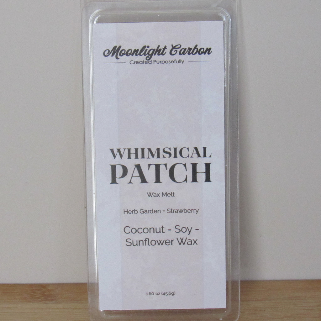 Wax melt package labeled 'Whimsical Patch' with branding on a plain background. Fragrance notes include herbal garden and strawberries. 