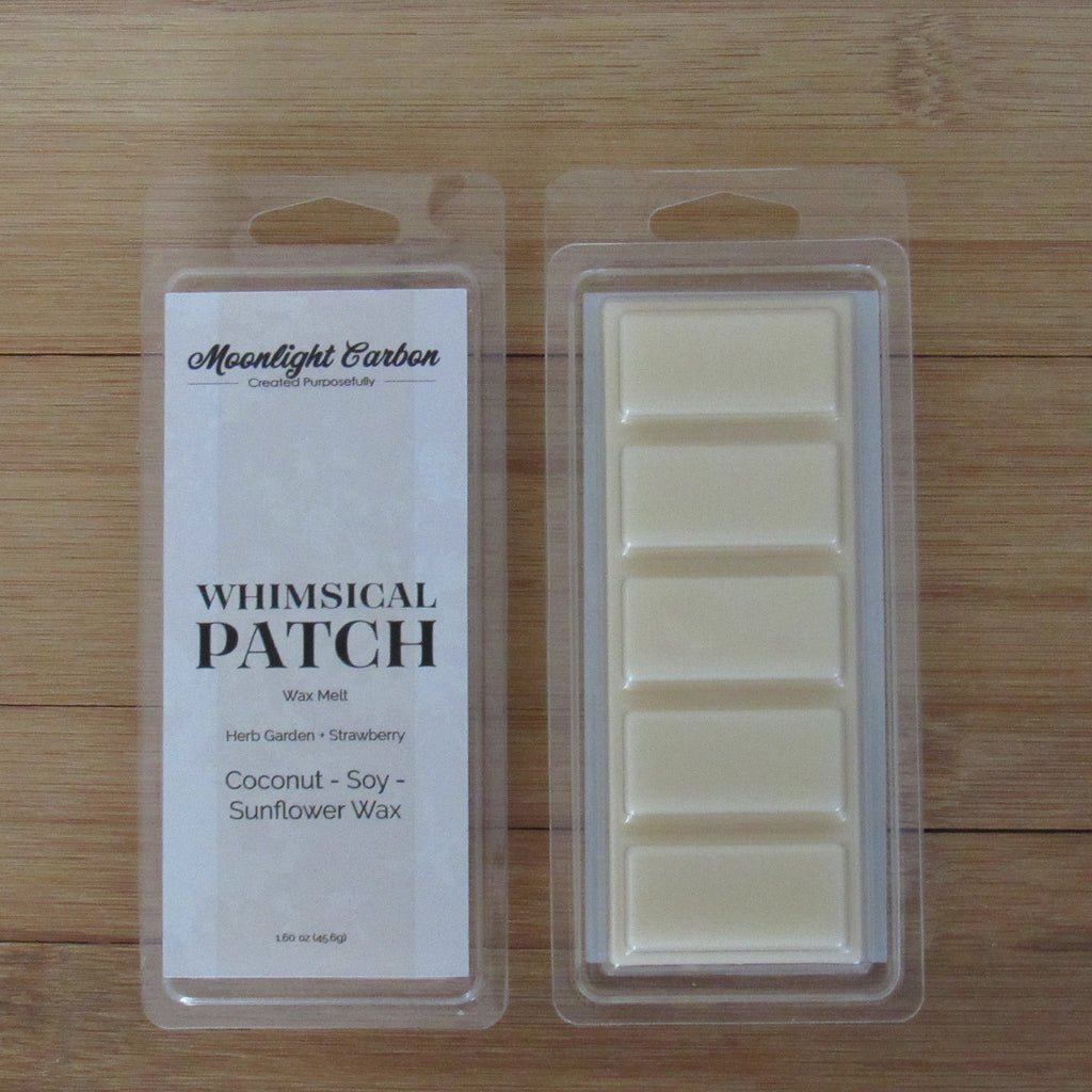 Wax melts in packaging with 'Moonlight Carbon' branding on a wooden surface. Shows back of packaging where wax melts are divided into 5 parts.