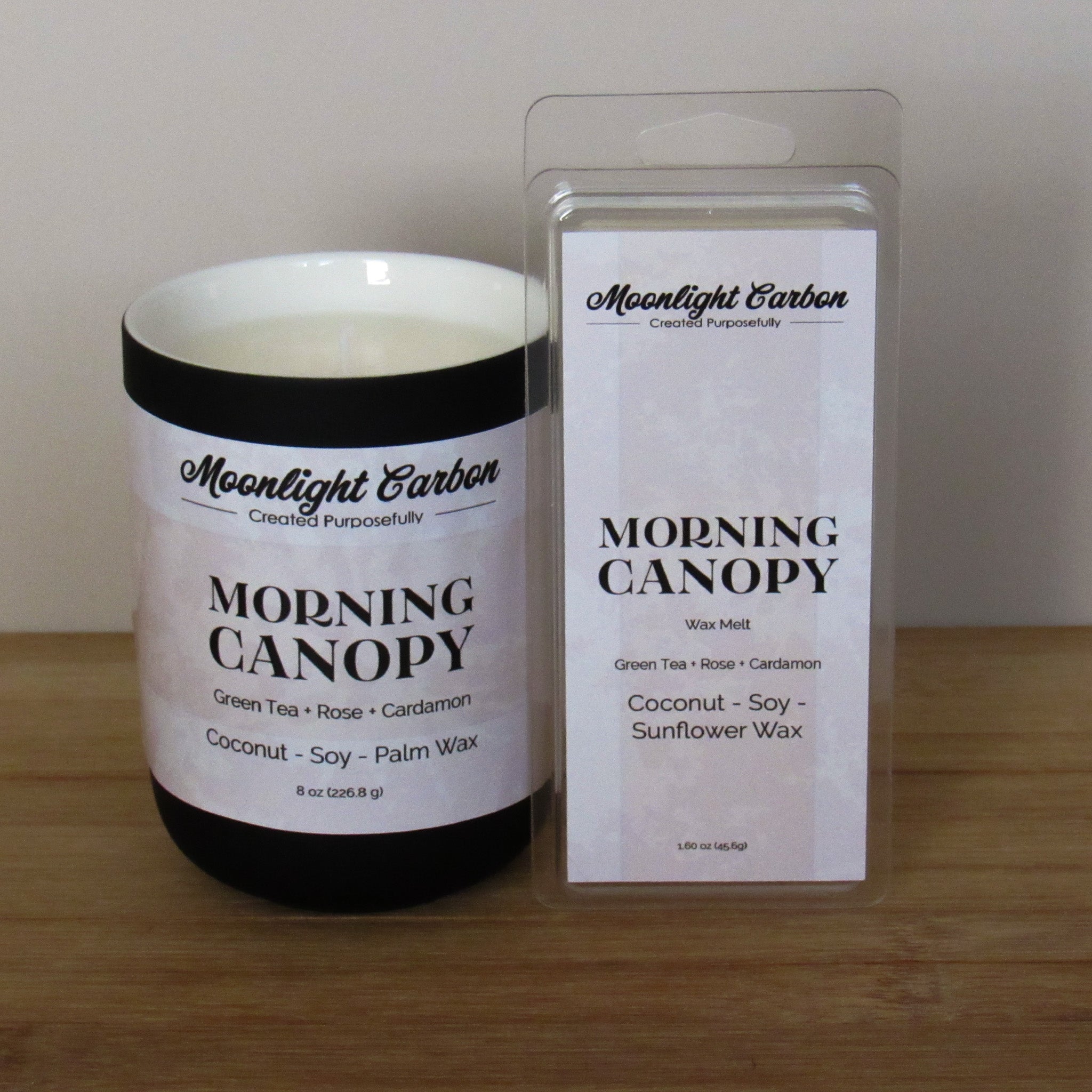 Candle and wax melt packaging of 'Morning Canopy' by Moonlight Carbon on a wooden surface.