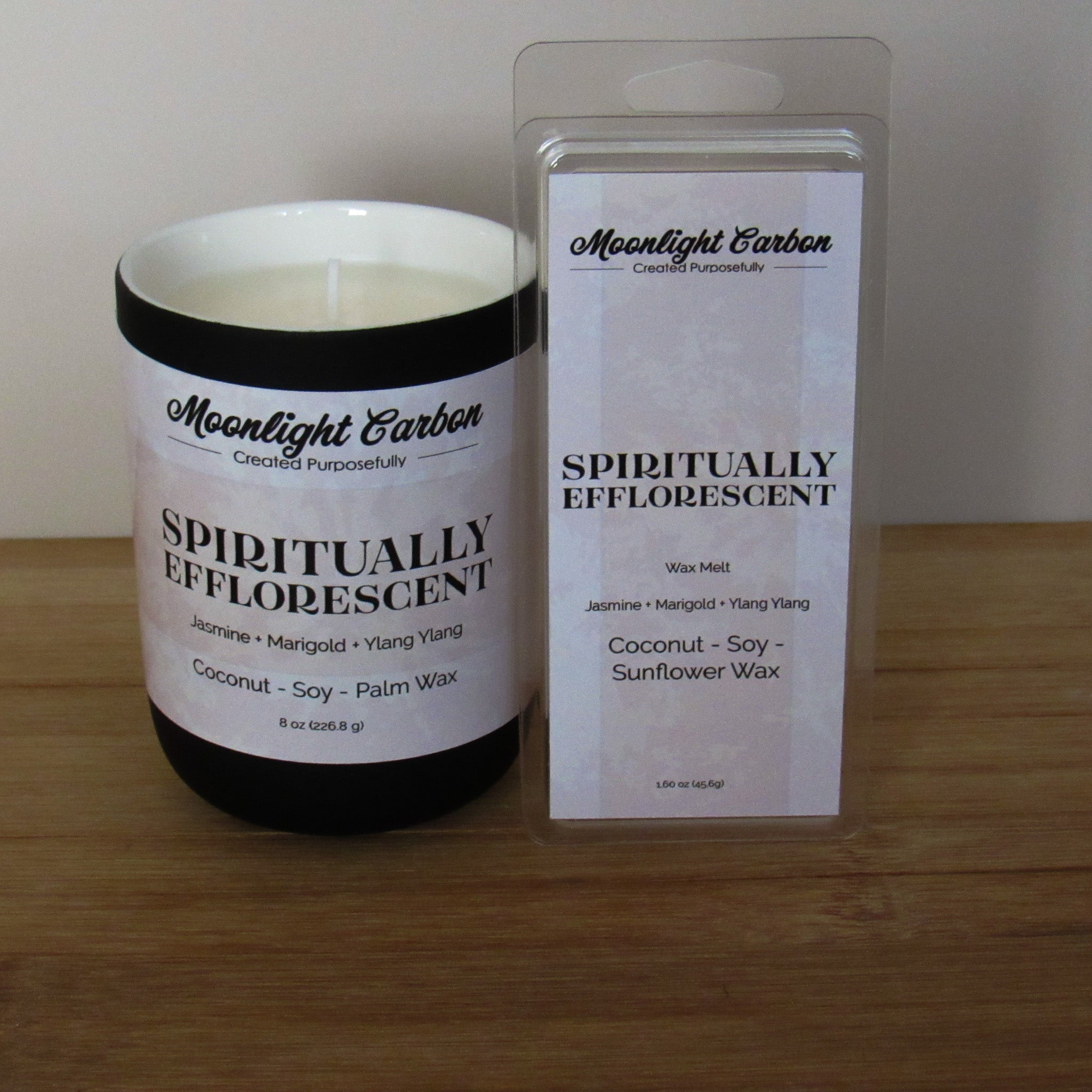 Candle and wax melt packaging labeled 'Spiritually Efflorescent' on a wooden surface.