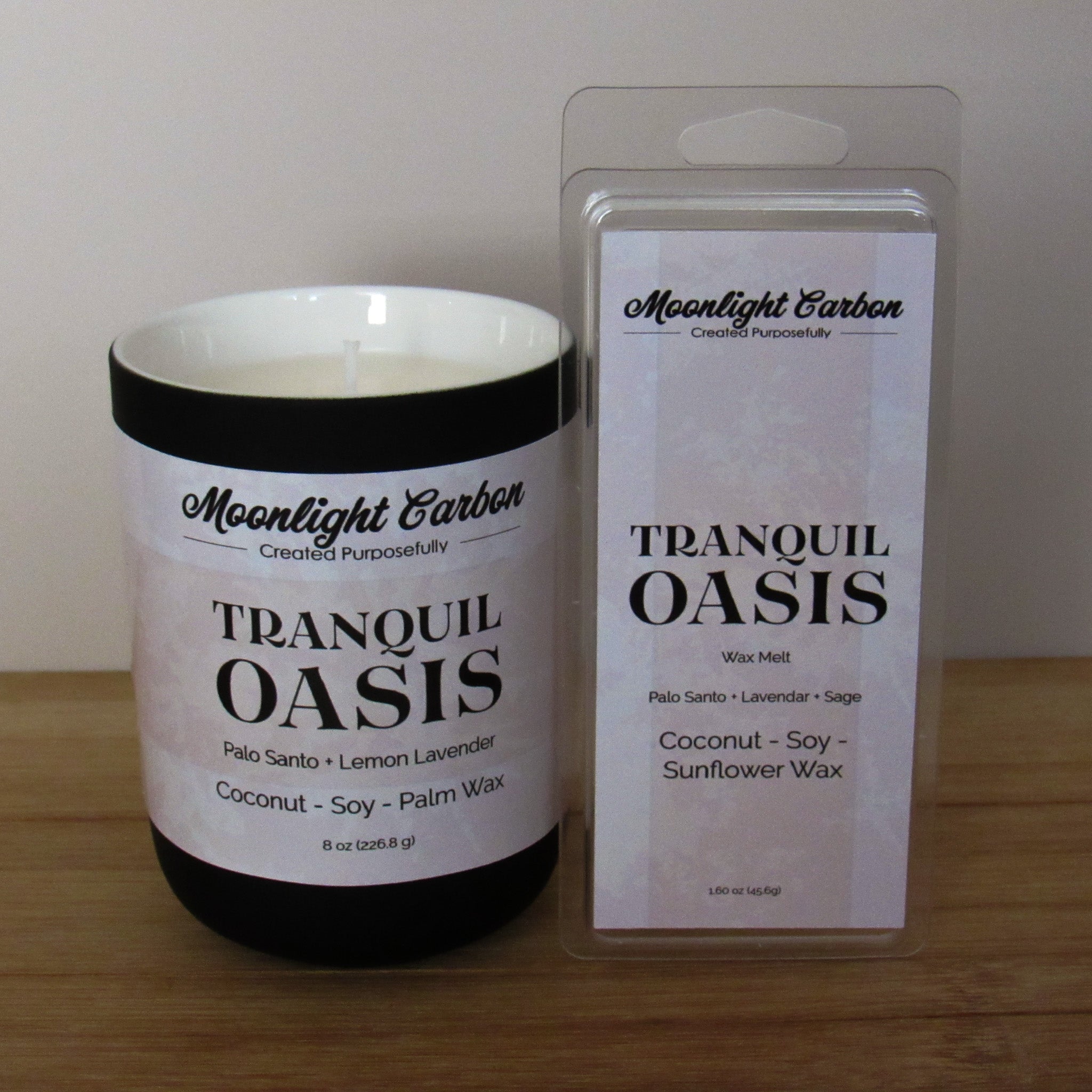 Candle labeled 'Tranquil Oasis' by Moonlight Carbon on a wooden surface. Paired with wax melt packaging. 