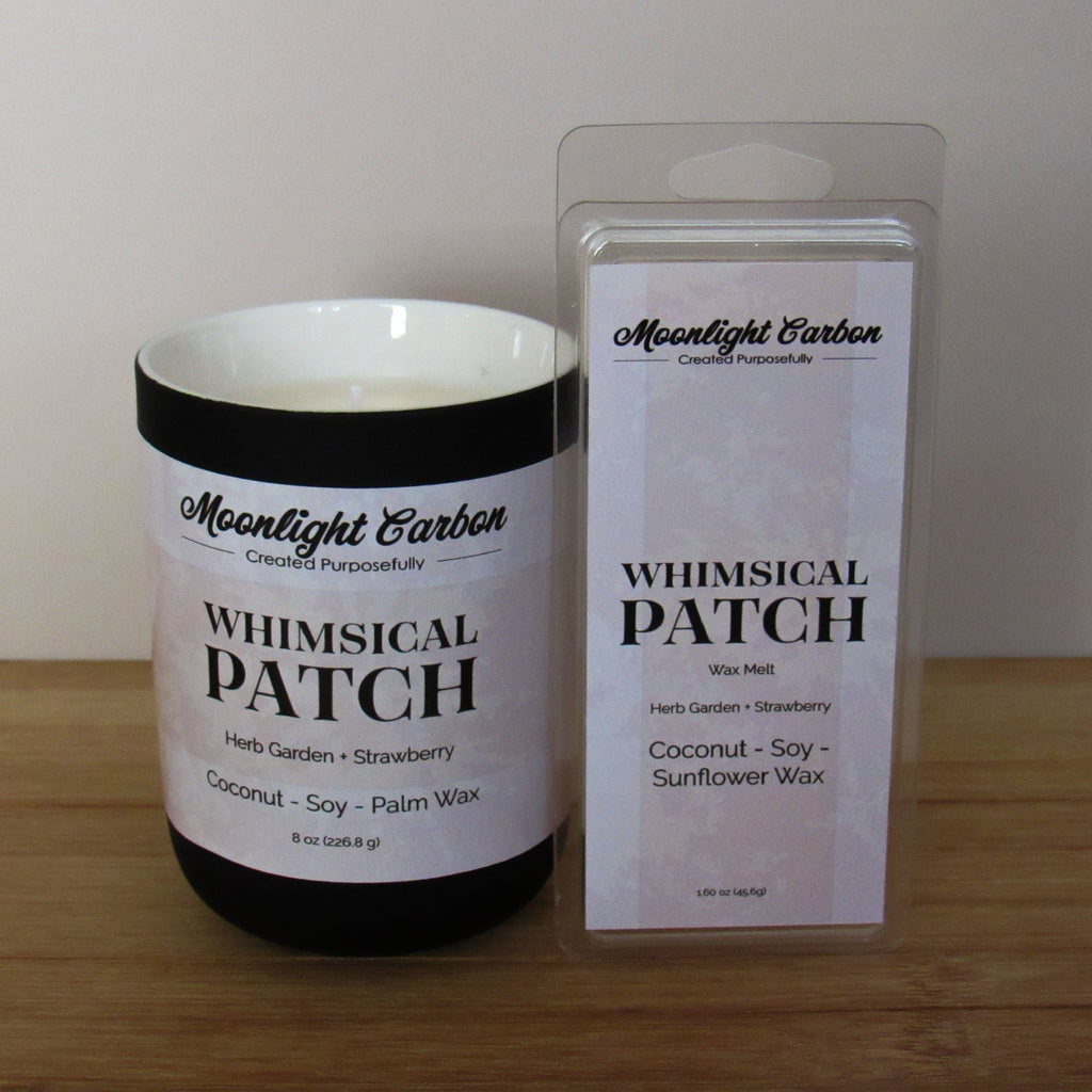 Candle labeled 'Whimsical Patch' by Moonlight Carbon with its wax melt packaging on a wooden surface.